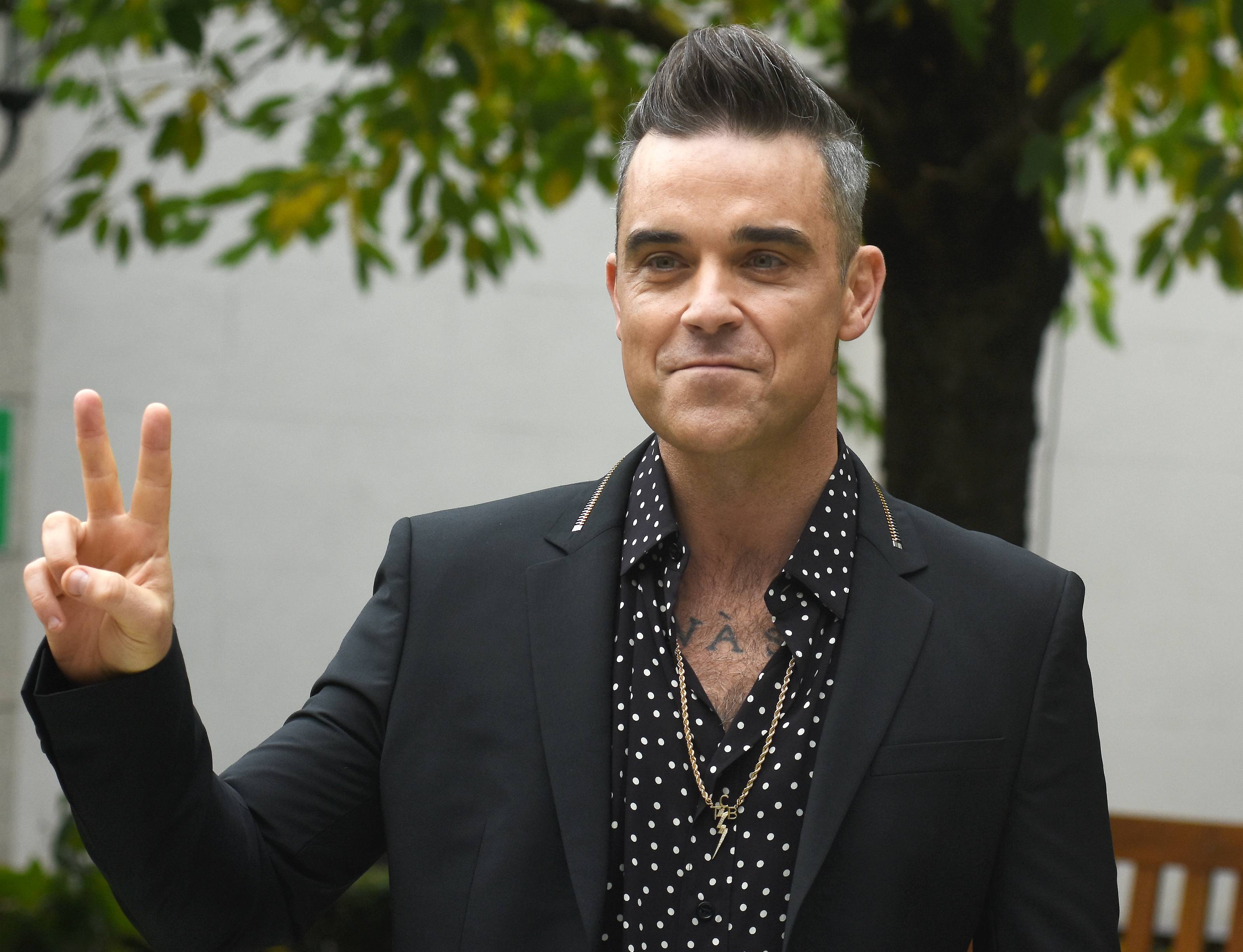 Robbie Williams may face fine for obscene gesture during World Cup ...